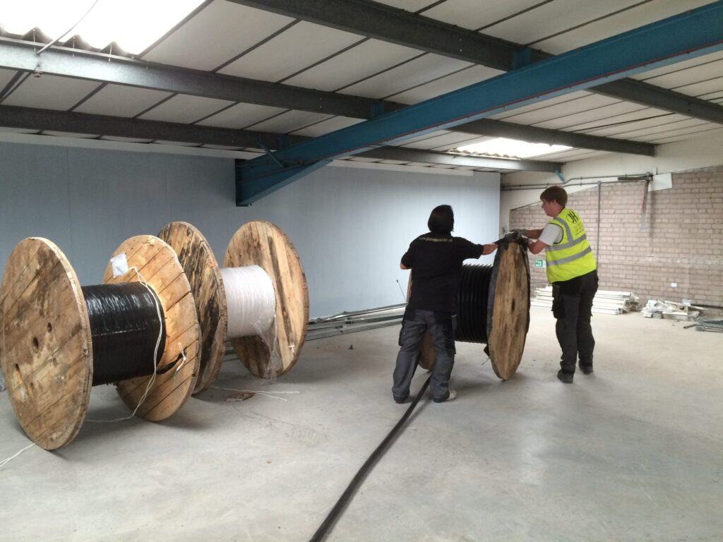 Picture of 2 people rolling out wires