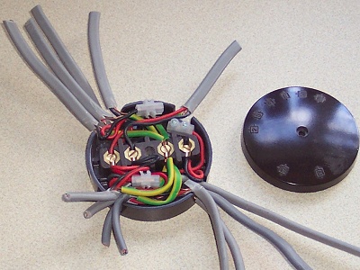 Open electrical junction box containing multiple wires and terminal connections.