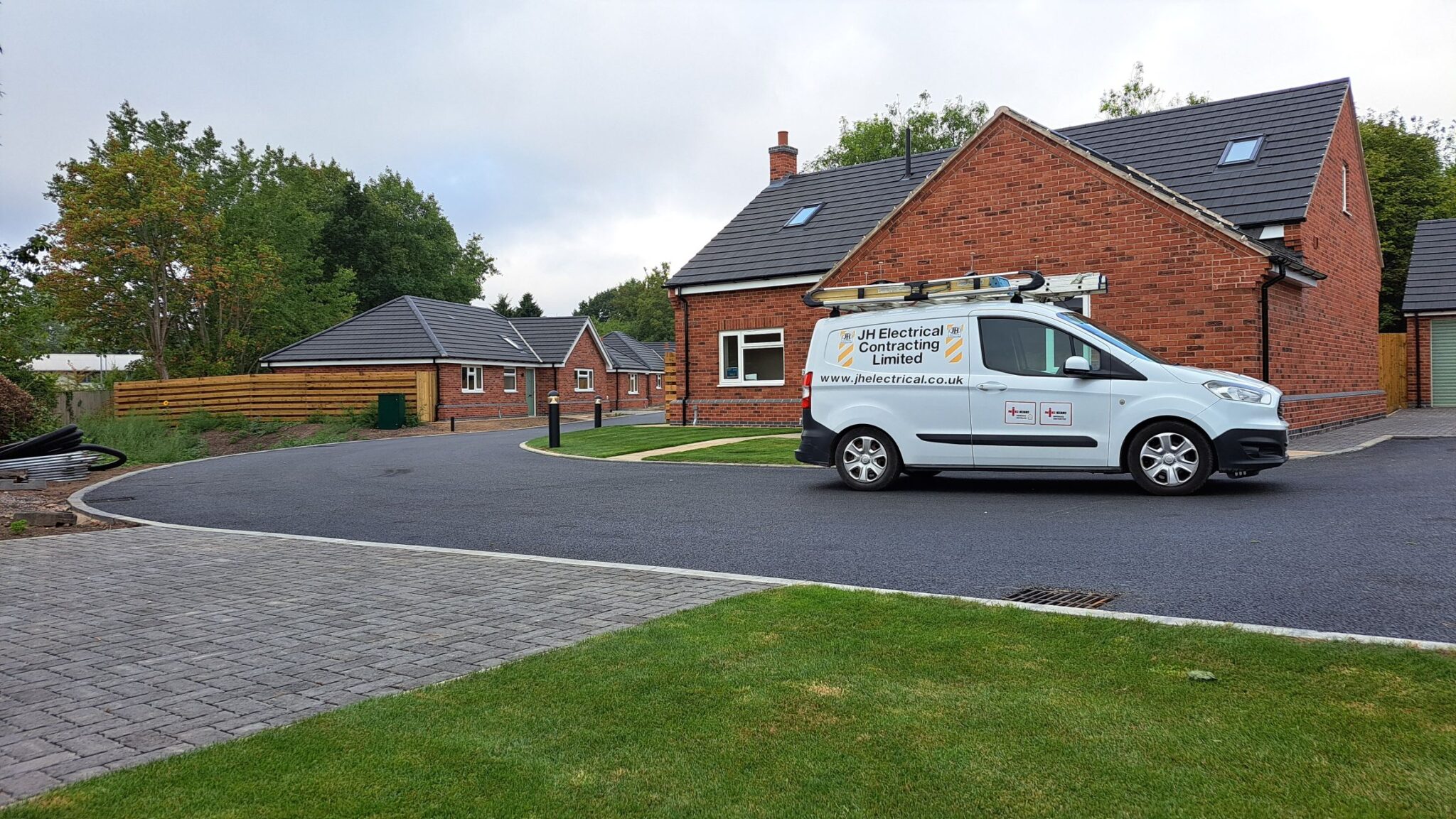JH Electrical Contracting van at an industrial electrical installation site.