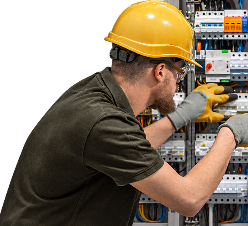 Qualified electrician inspecting an electrical distribution board.